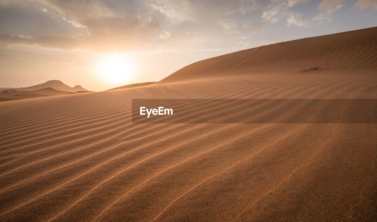 Scenic view of desert against sky during sunset