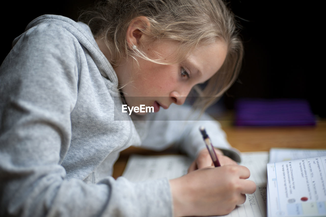 Close-up of girl studying
