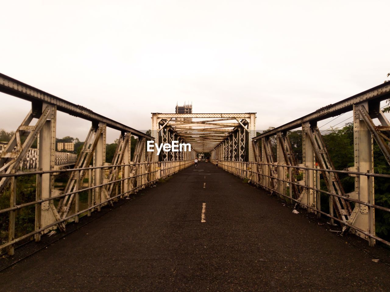 Bridge over road against clear sky