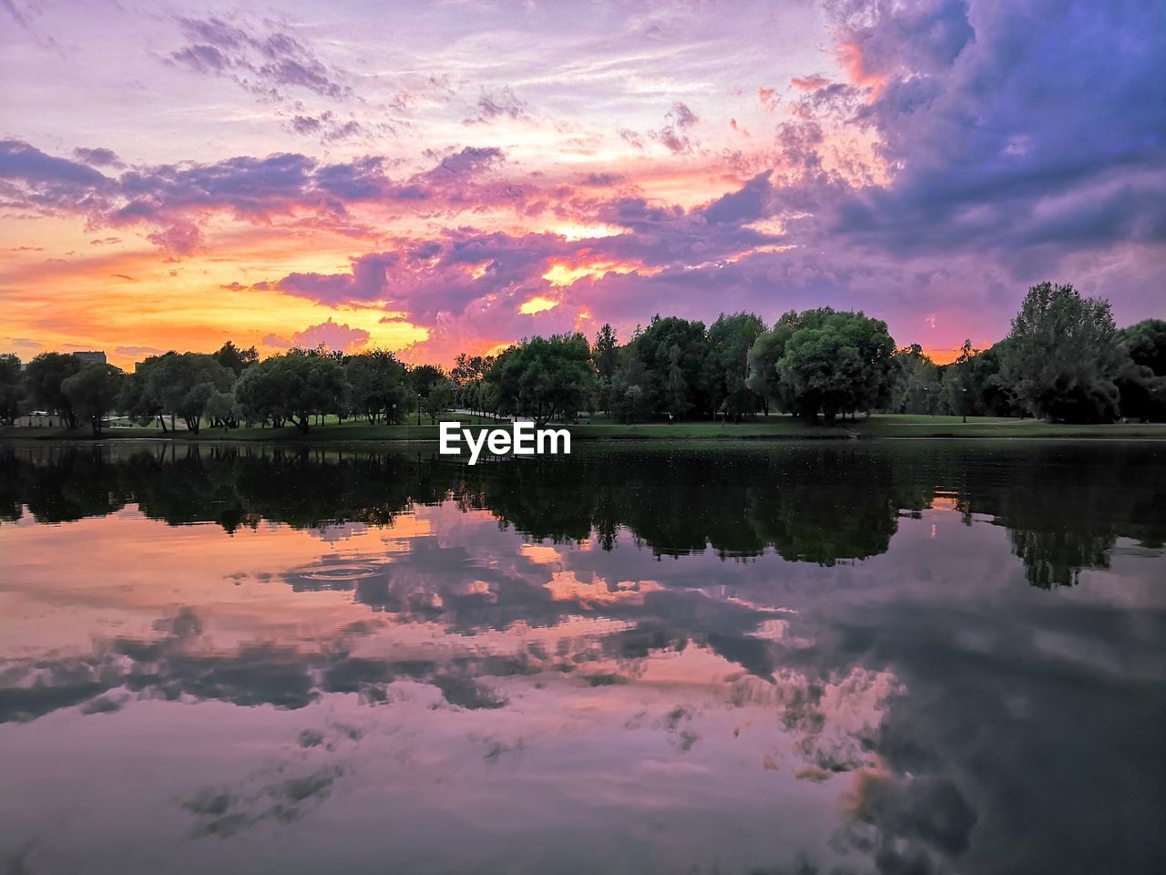 REFLECTION OF SKY ON LAKE DURING SUNSET
