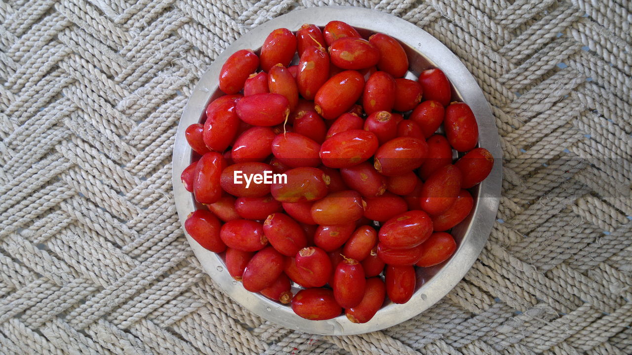High angle view of red fruits in bowl on table