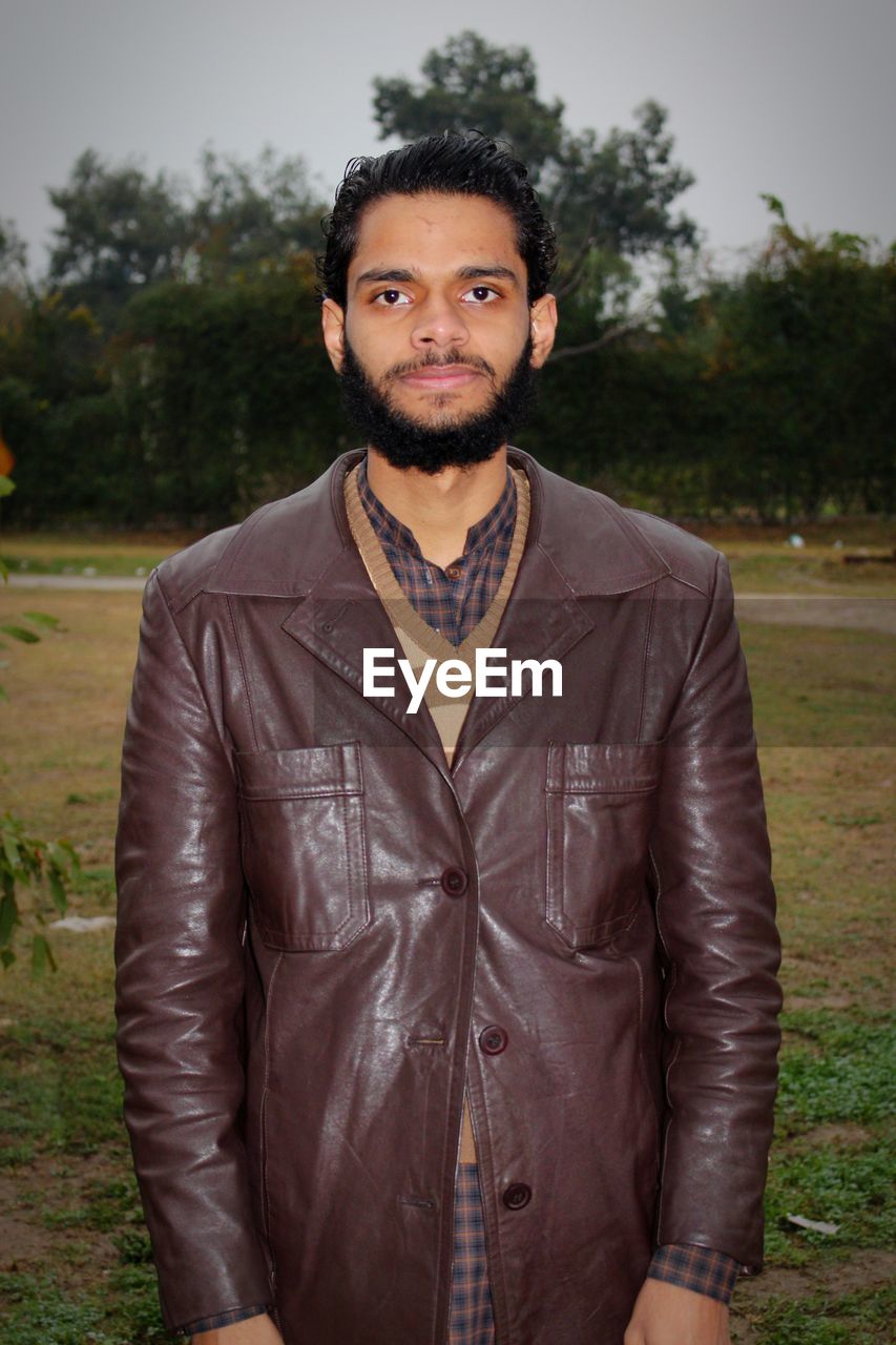 portrait, one person, looking at camera, leather jacket, adult, jacket, leather, front view, young adult, men, standing, beard, clothing, facial hair, serious, waist up, cool attitude, fashion, individuality, sky, nature, person, black hair, casual clothing, spring, lifestyles