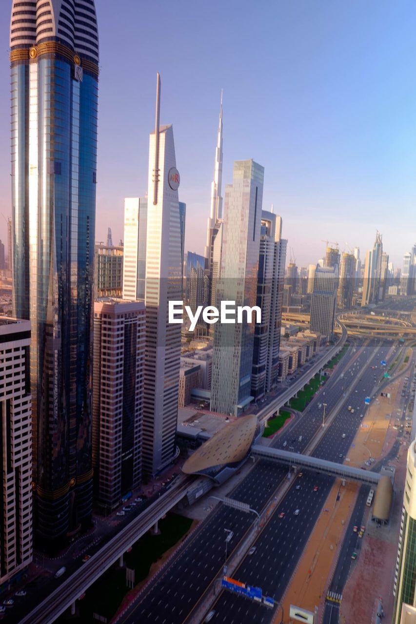 Modern skyscrapers in city against clear sky