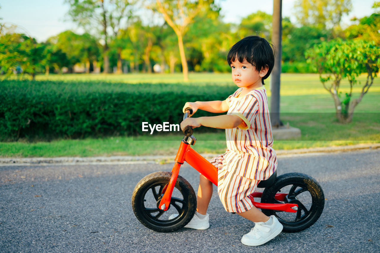 Side view of boy with bicycle