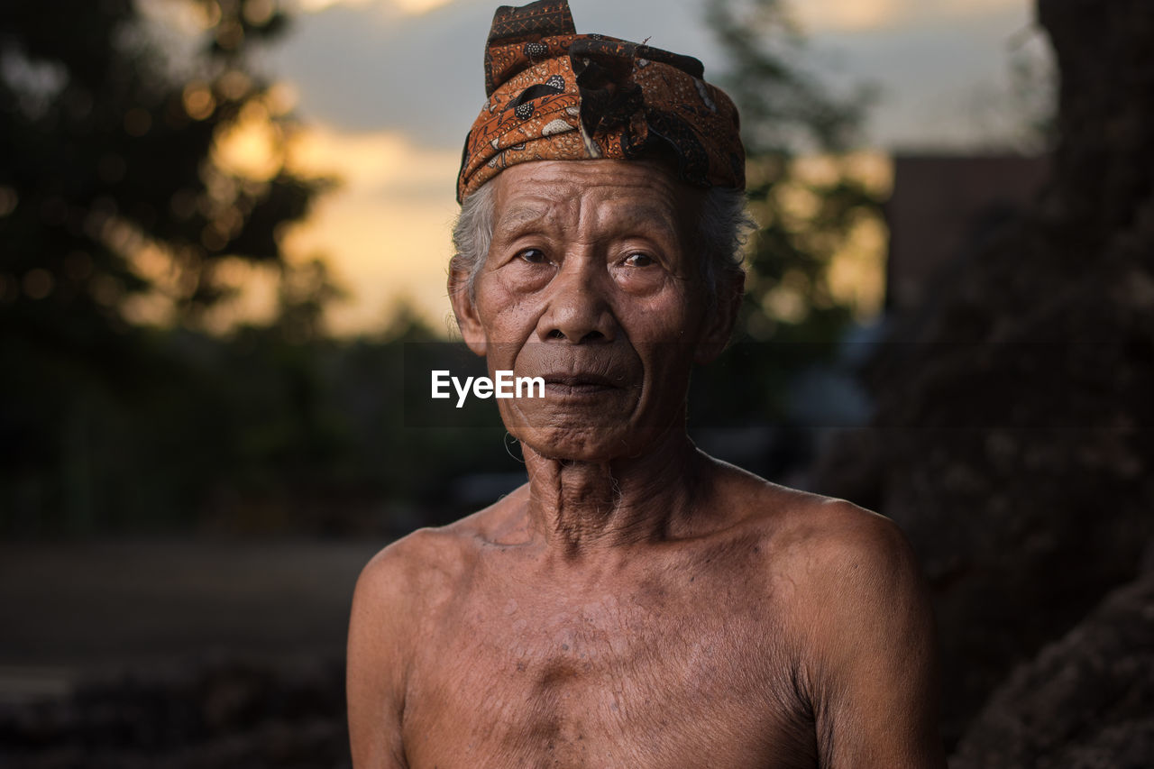 Portrait of old man primitive tribe against blurred background