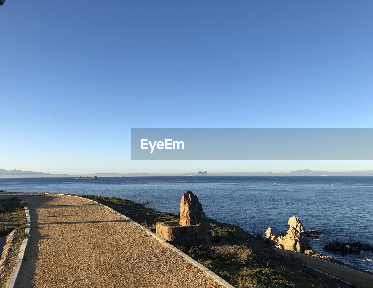 Scenic view of sea against clear blue sky