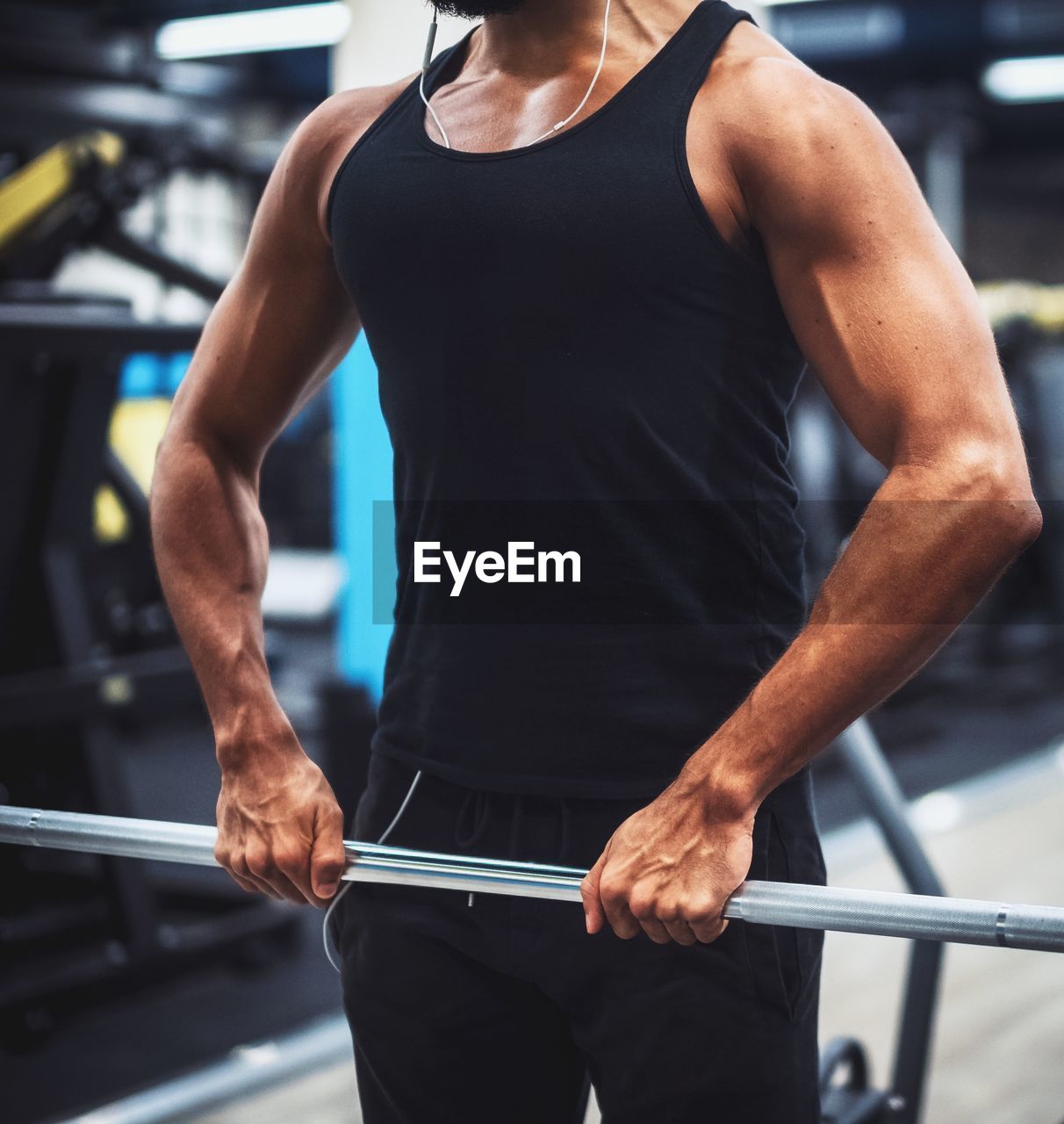 Midsection of man exercising at gym