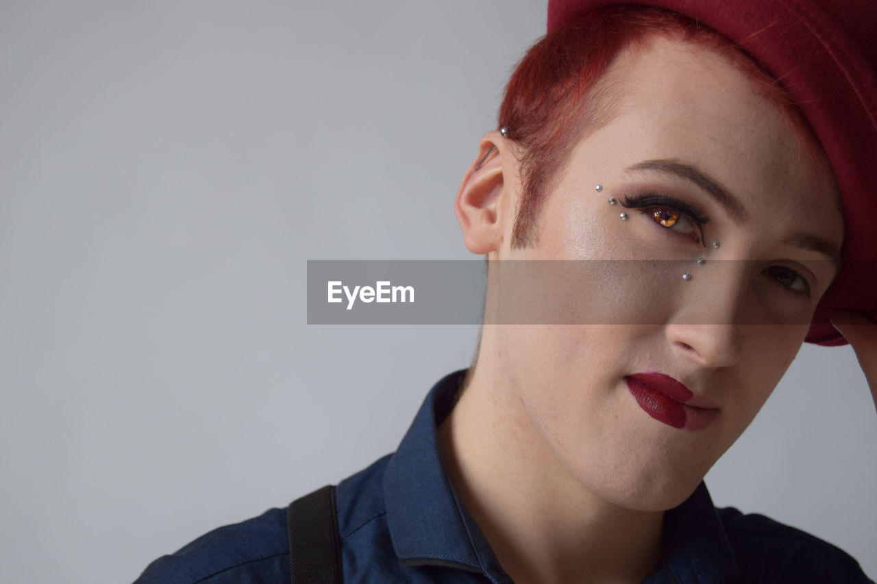 Portrait of drag queen against gray background