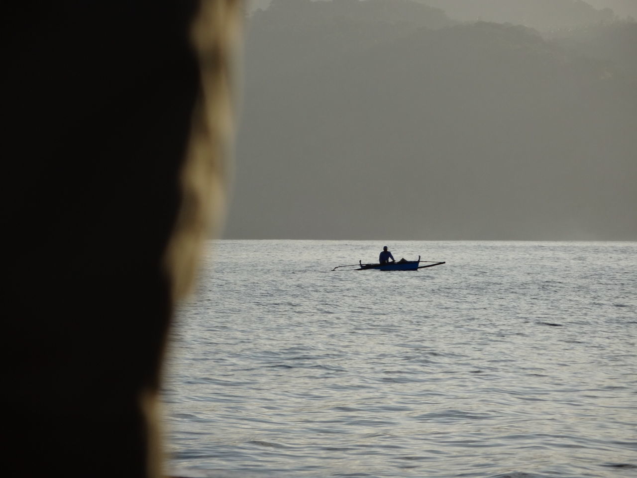 Silhouette boat in calm sea against clear sky