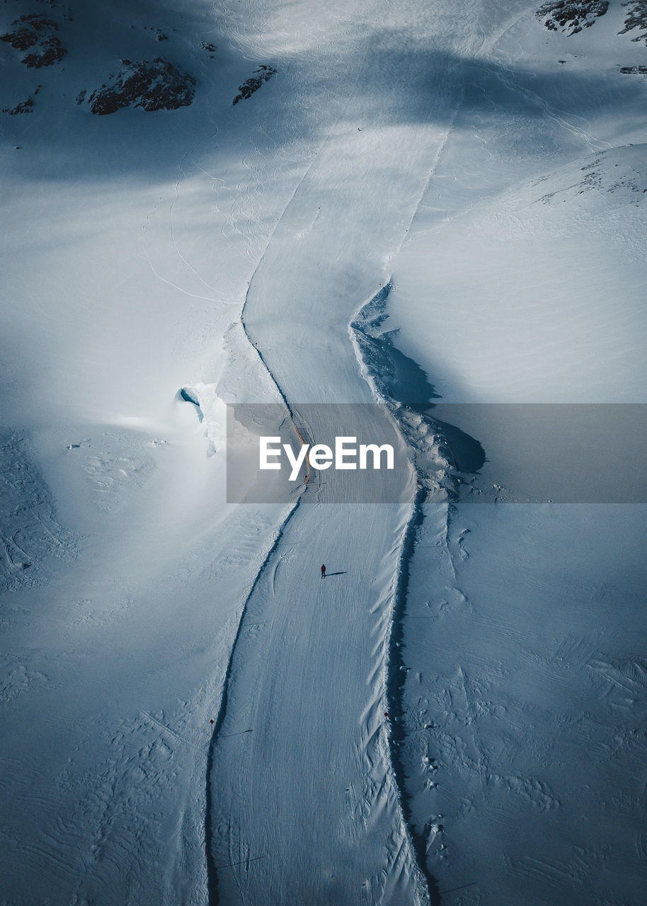 High angle view of people skiing on snow covered mountain