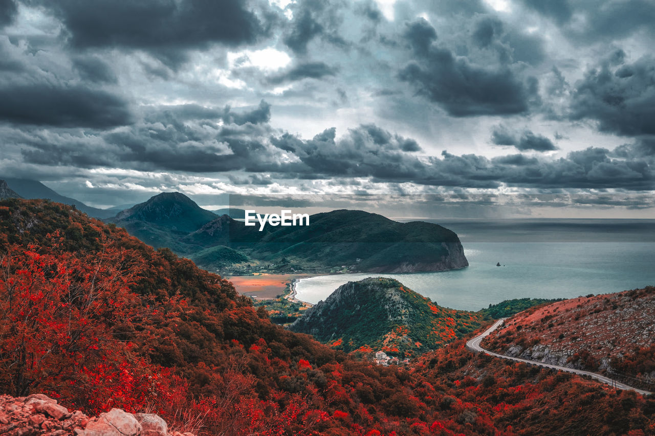 Scenic view of sea and mountains against sky