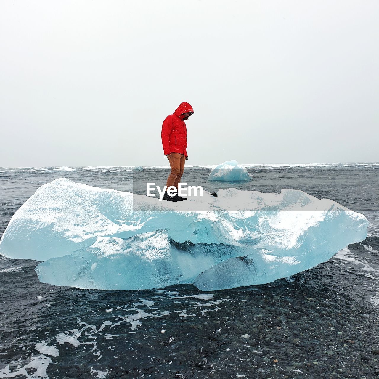 FULL LENGTH OF PERSON ON FROZEN SEA AGAINST SKY