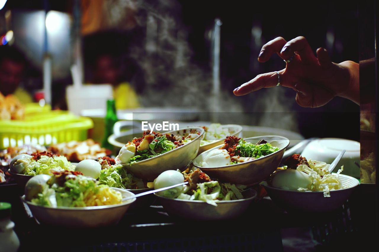 MIDSECTION OF PERSON HAVING FOOD IN BOWL