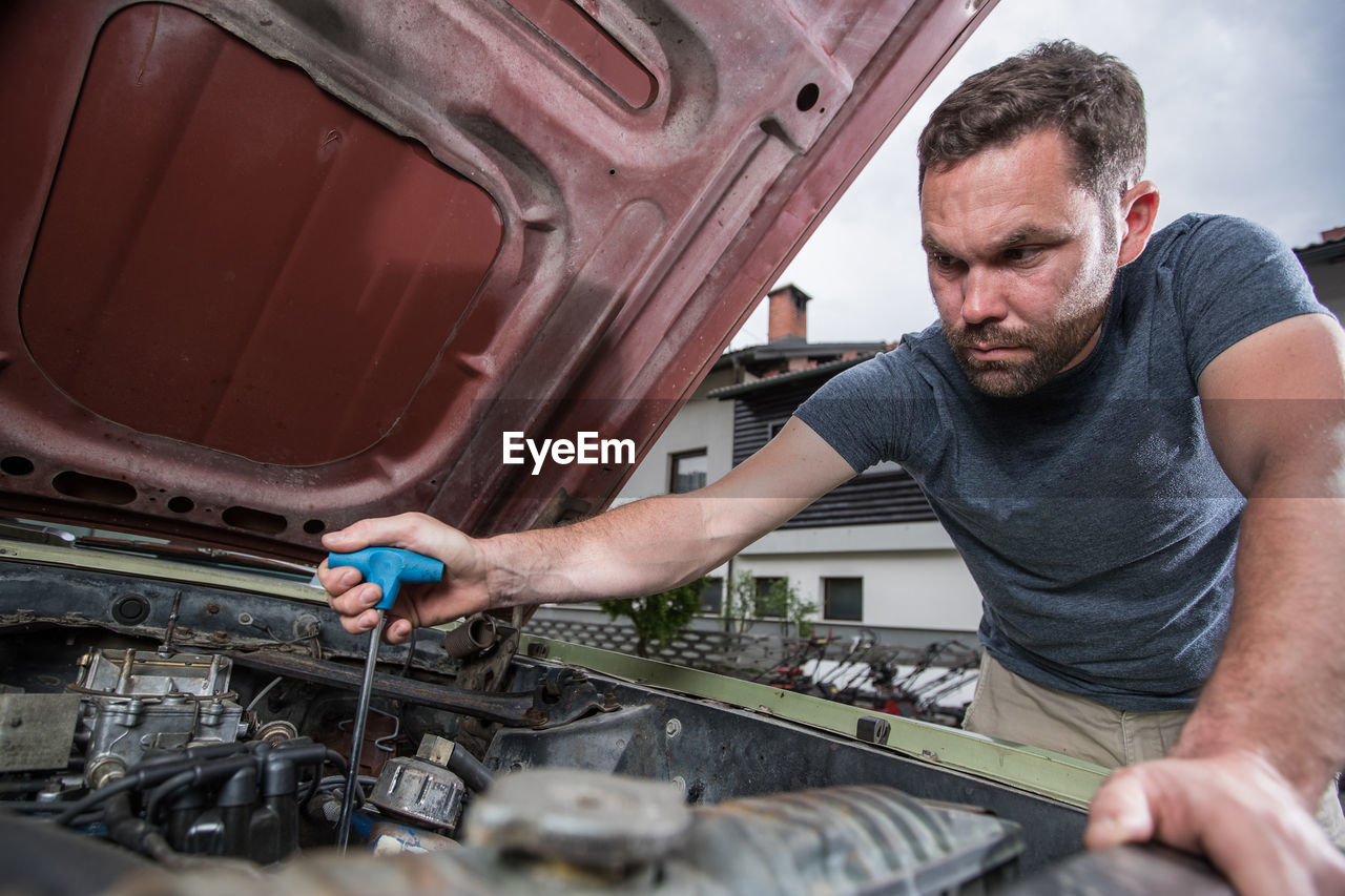 Man repairing car