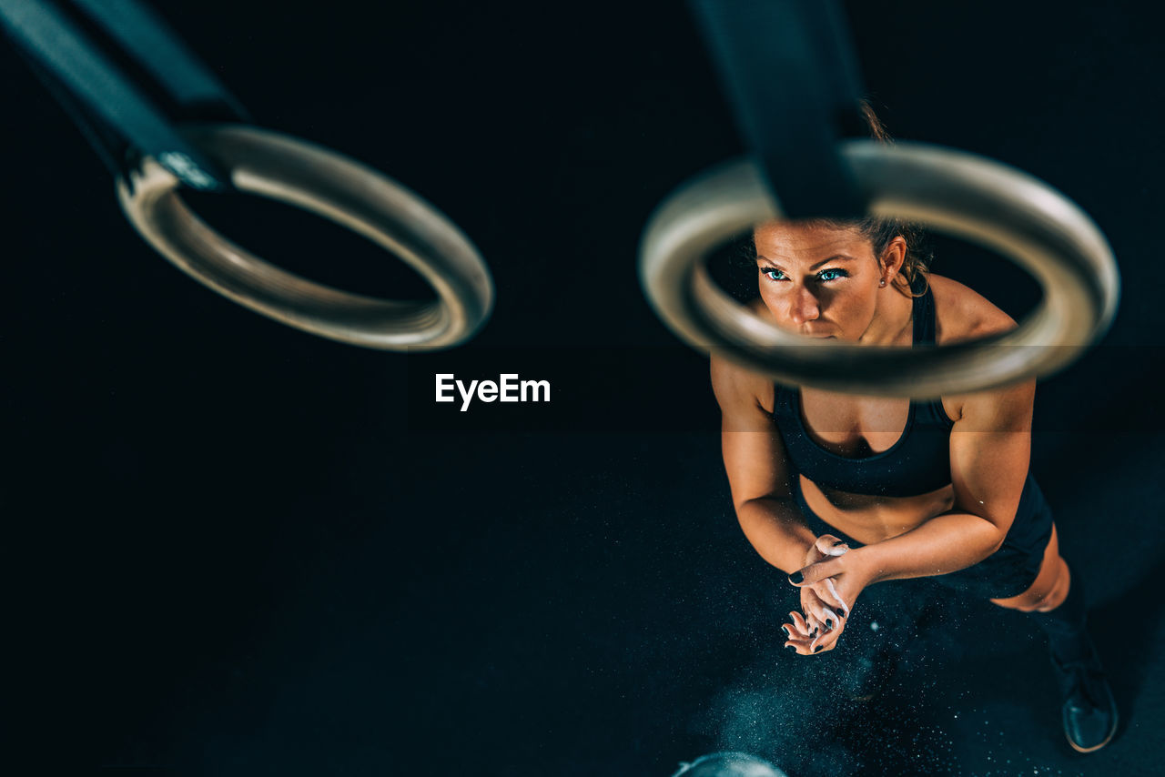 High angle view of woman over gymnastic rings 