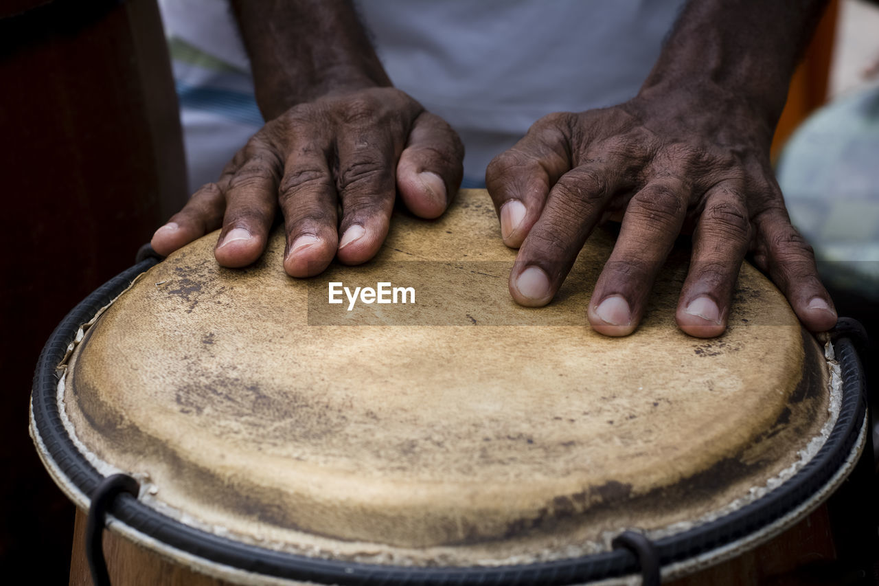 Hands of a musician playing percussion in presentation. 