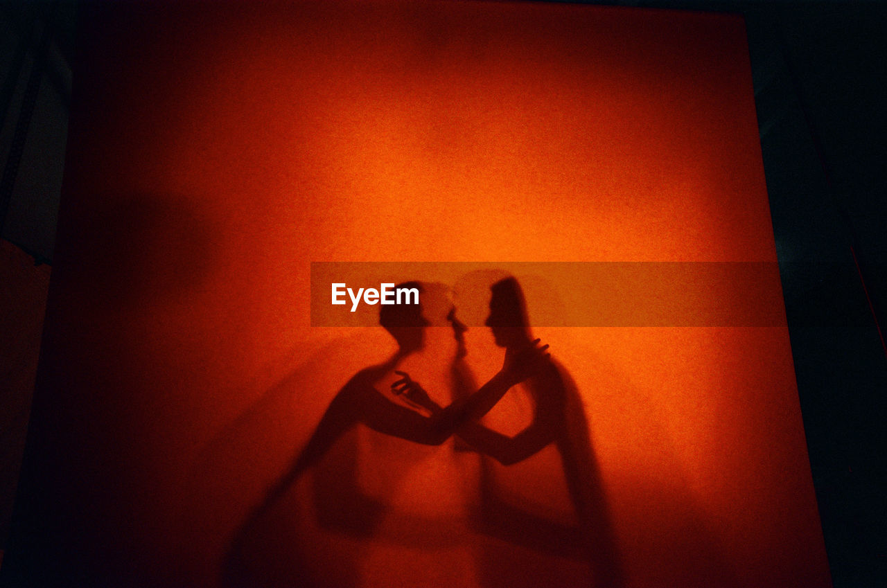Lovers shadows at orange background