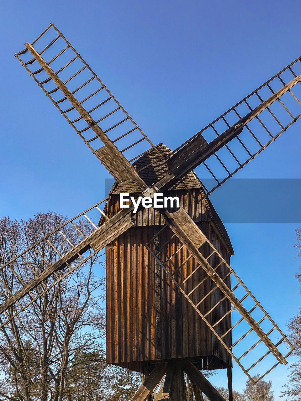 LOW ANGLE VIEW OF WINDMILL AGAINST BLUE SKY