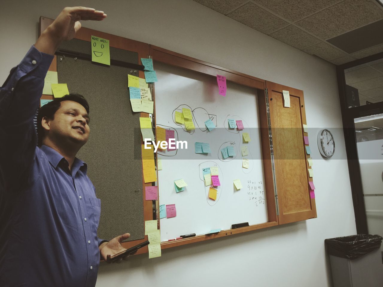 Young Man Giving Presentation In Board Room On Eyeem