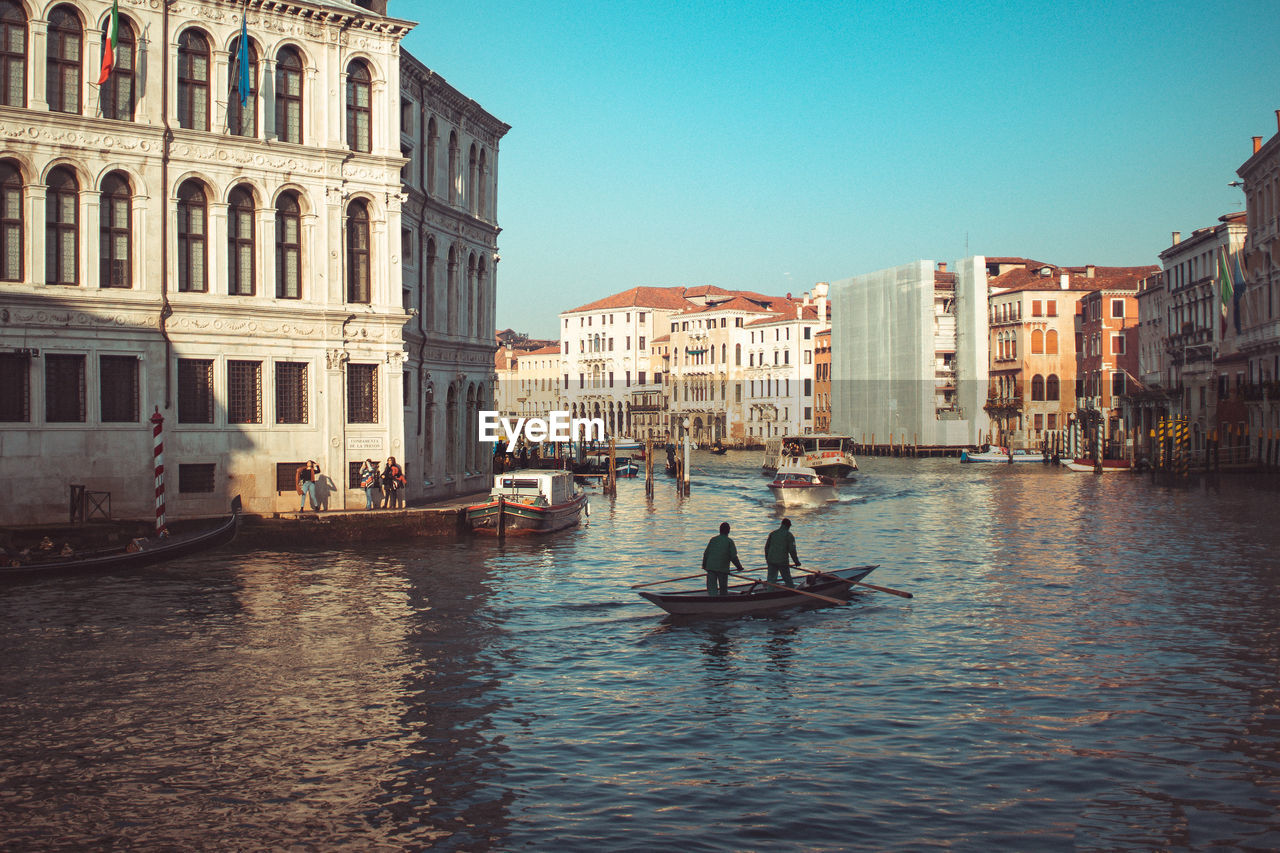 Rear view of people in boat on grand canal