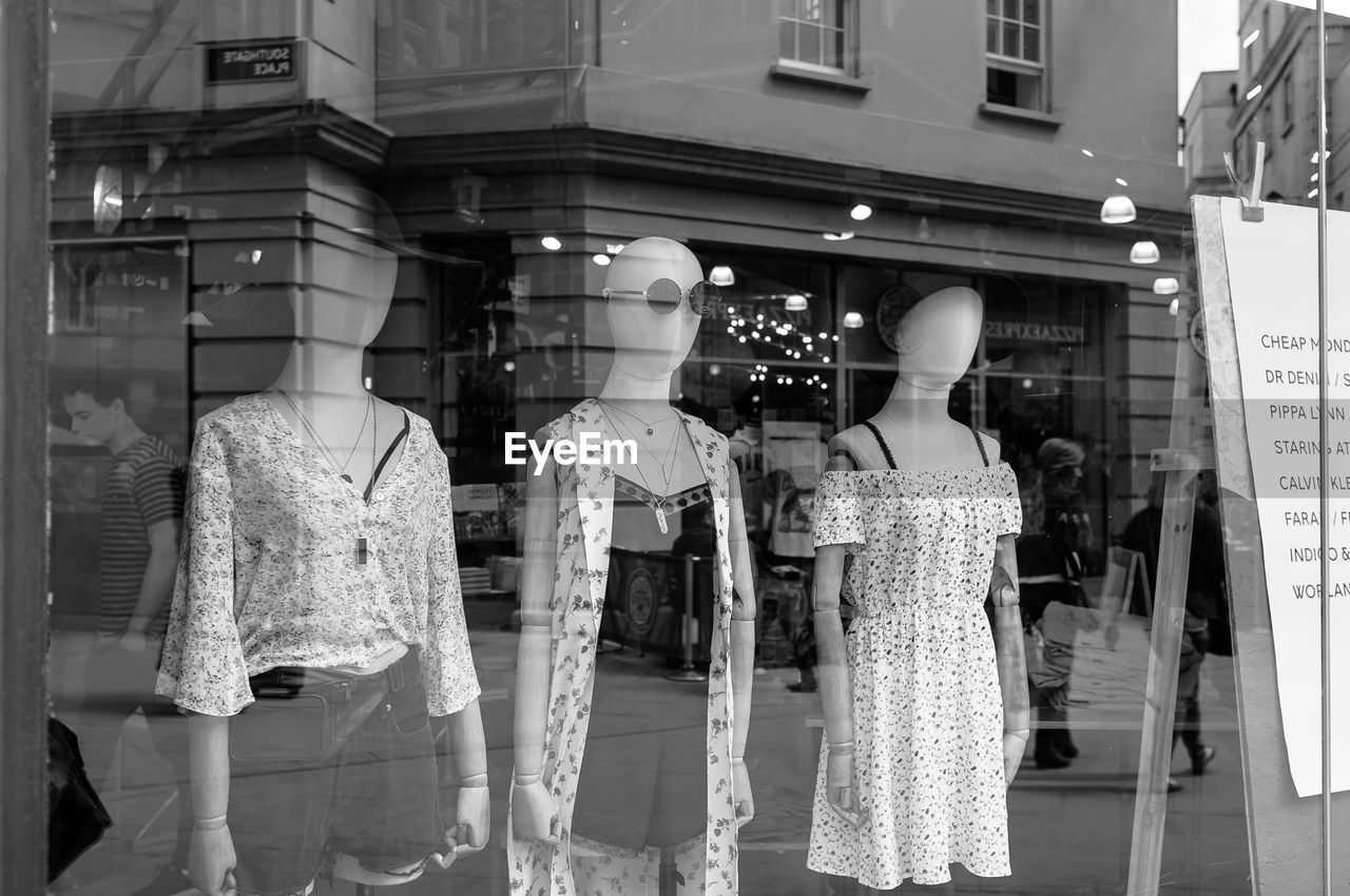 Mannequins at window display in shop