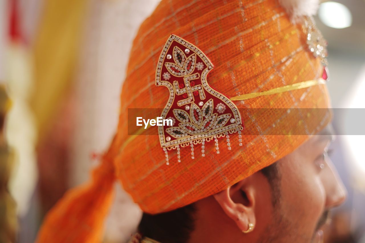 Close-up of young man wearing turban during wedding ceremony