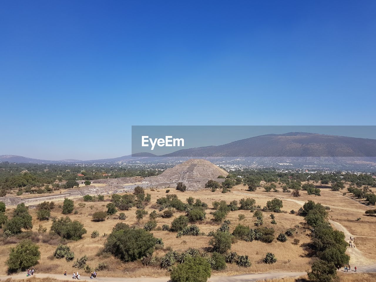 Scenic view of ancient pyramid against clear blue sky