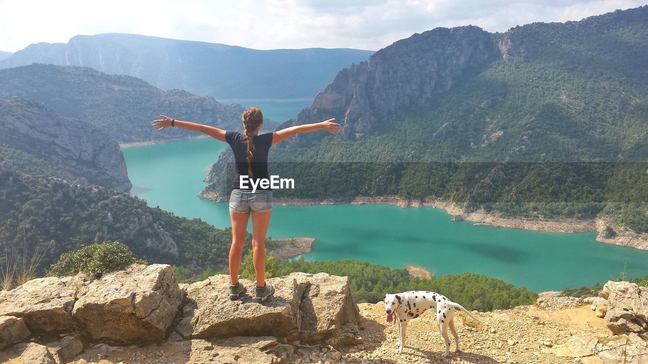 WOMAN STANDING ON MOUNTAIN
