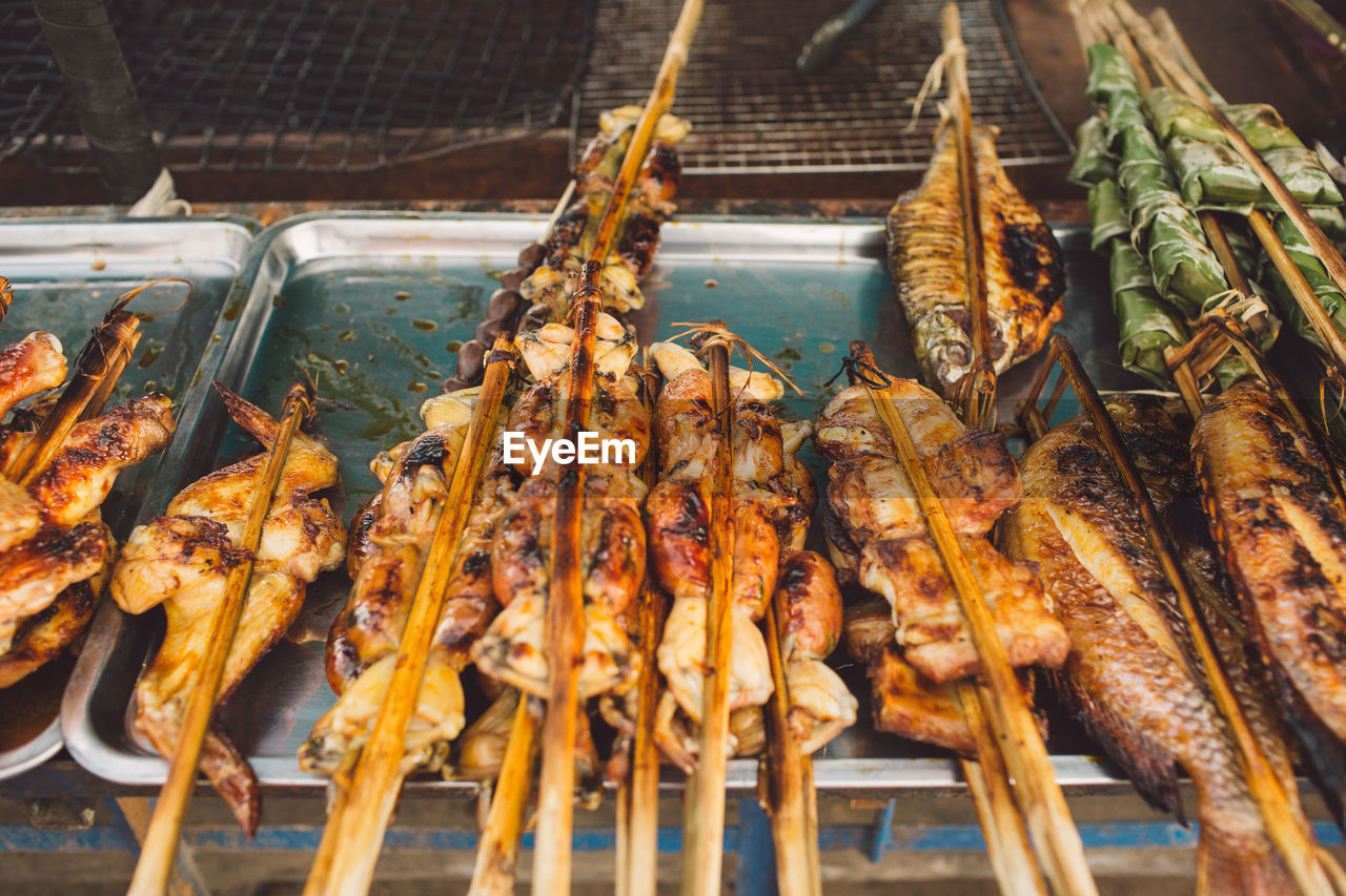 Grilled fishes and chicken meat at market for sale