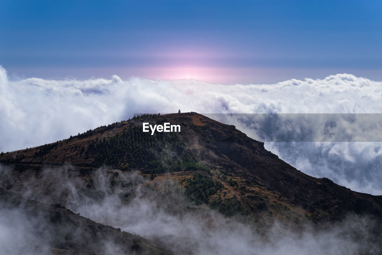 Low angle view of volcanic mountain against sky