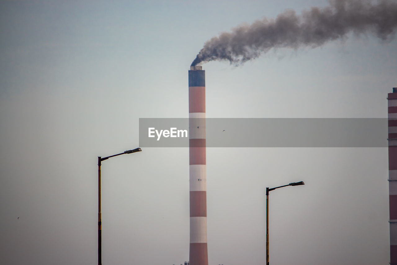 LOW ANGLE VIEW OF SMOKE STACK AGAINST SKY
