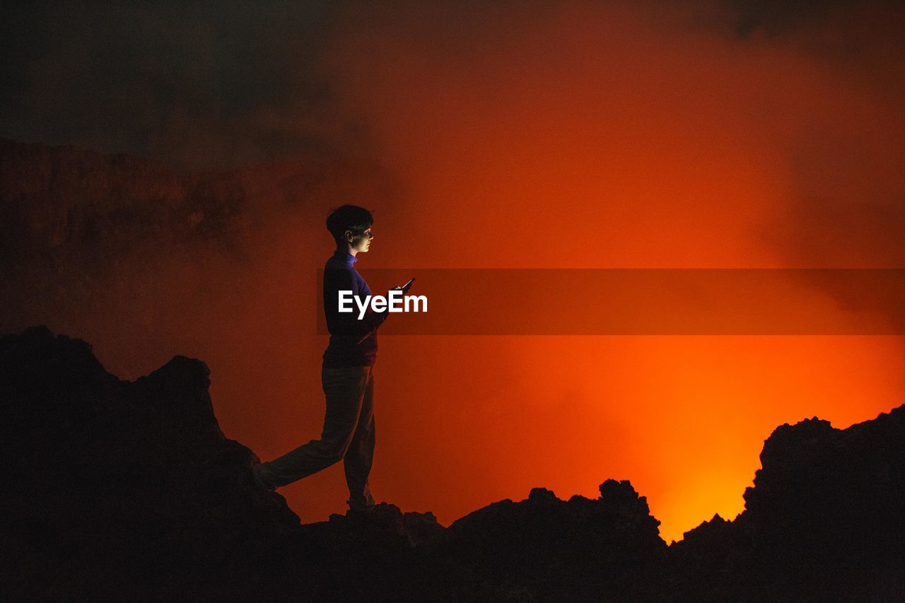 Woman looking at volcanic eruption