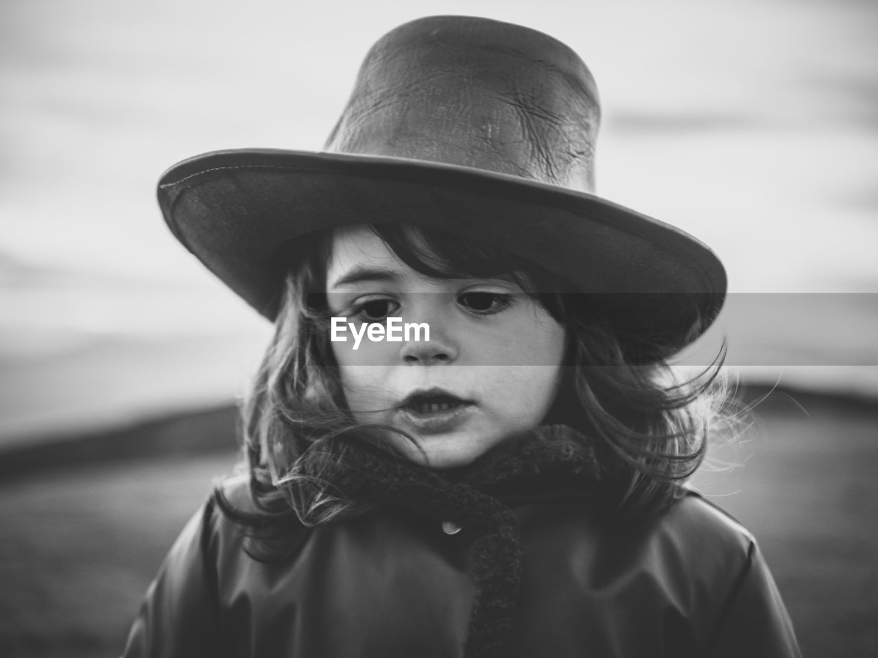 Close-up of cute girl wearing hat looking down while standing outdoors