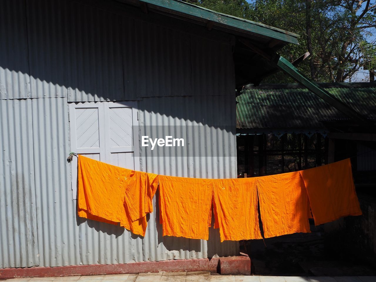 CLOTHES DRYING AGAINST ORANGE WALL