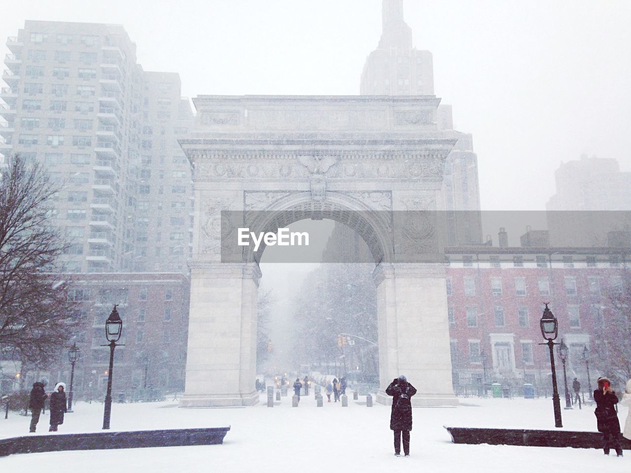 Low angle view of washington square arch and buildings in foggy weather