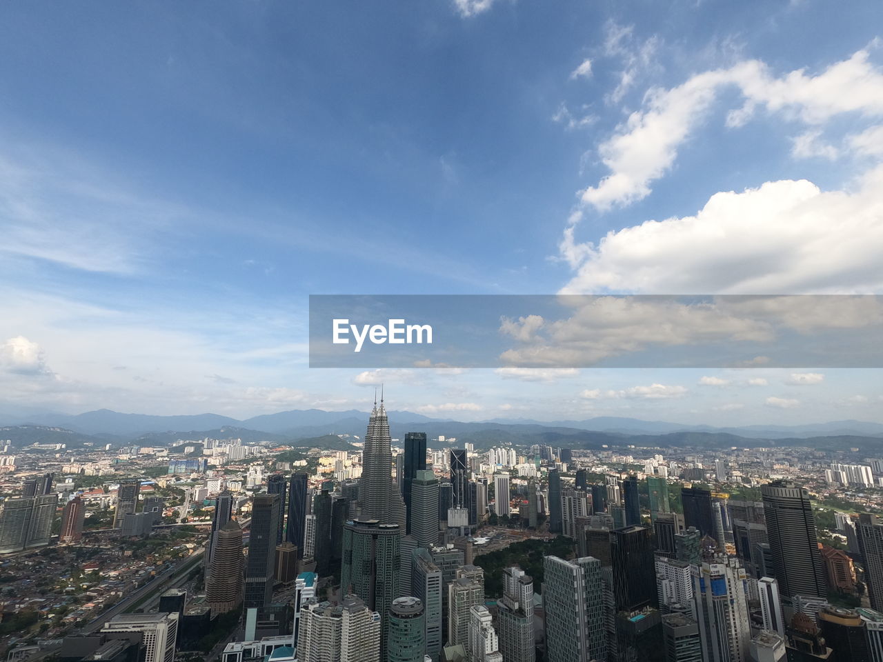AERIAL VIEW OF MODERN BUILDINGS AGAINST SKY IN CITY