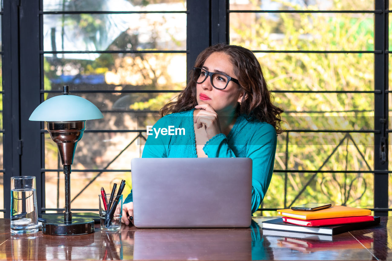 Businesswoman looking away while working in office
