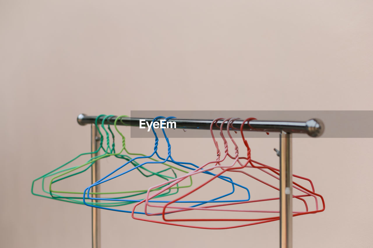 CLOSE-UP OF METAL HANGING AGAINST WHITE BACKGROUND
