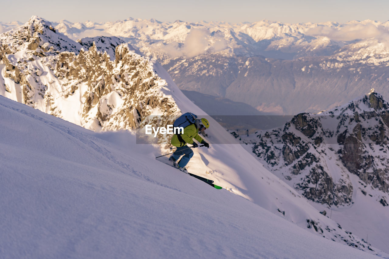 Man skiing on snowcapped mountains