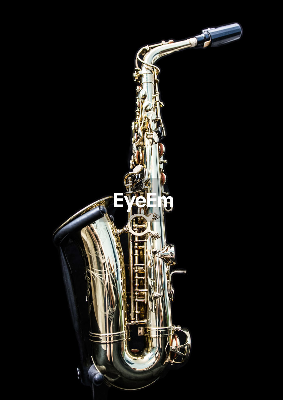 Saxophone against black background