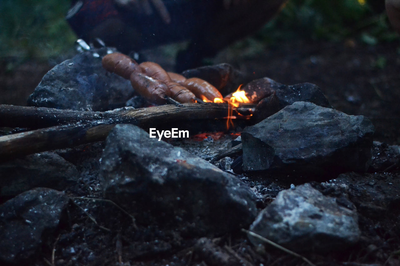Close-up of sausage on campfire