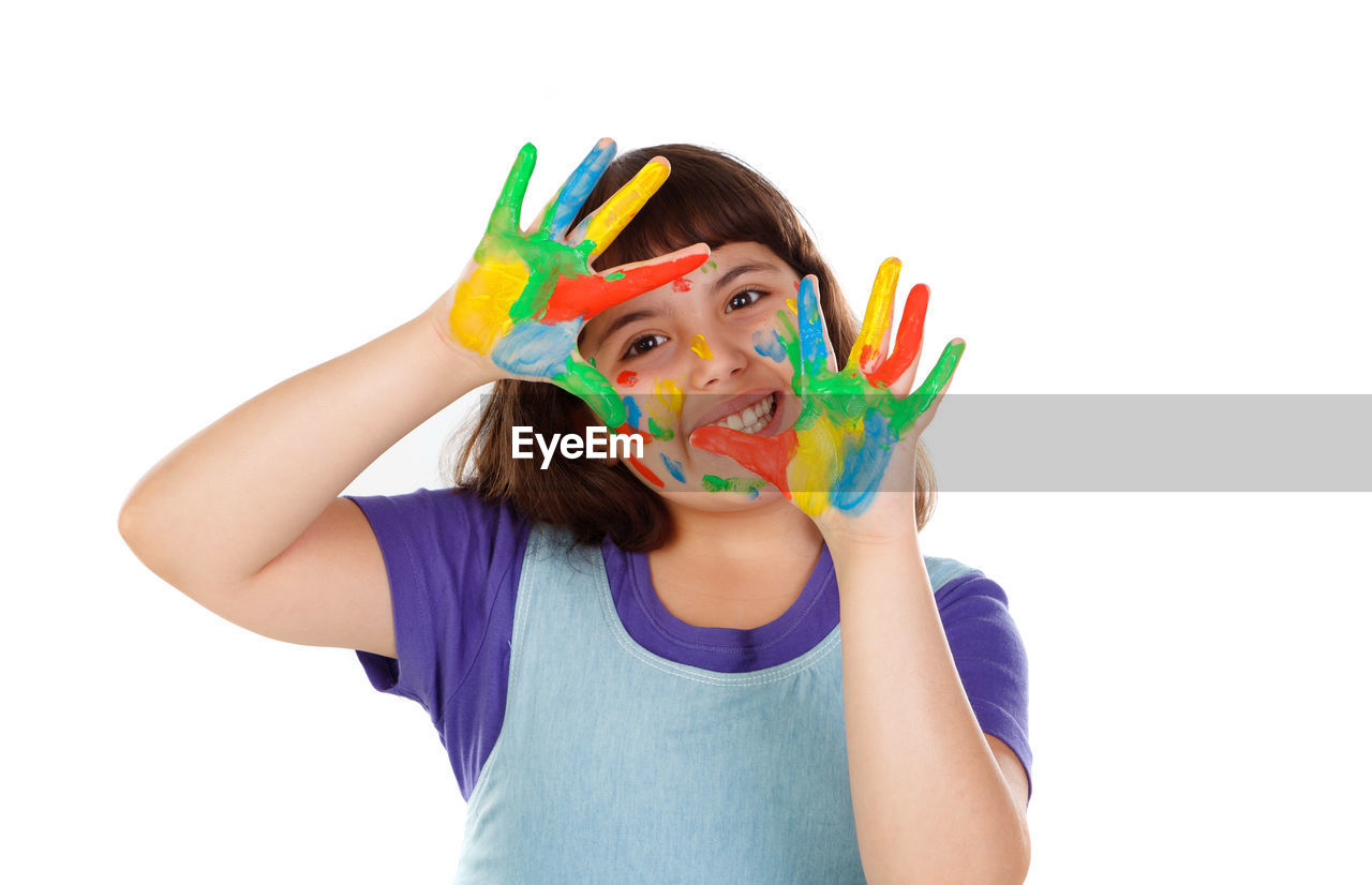 PORTRAIT OF GIRL HOLDING MULTI COLORED FACE