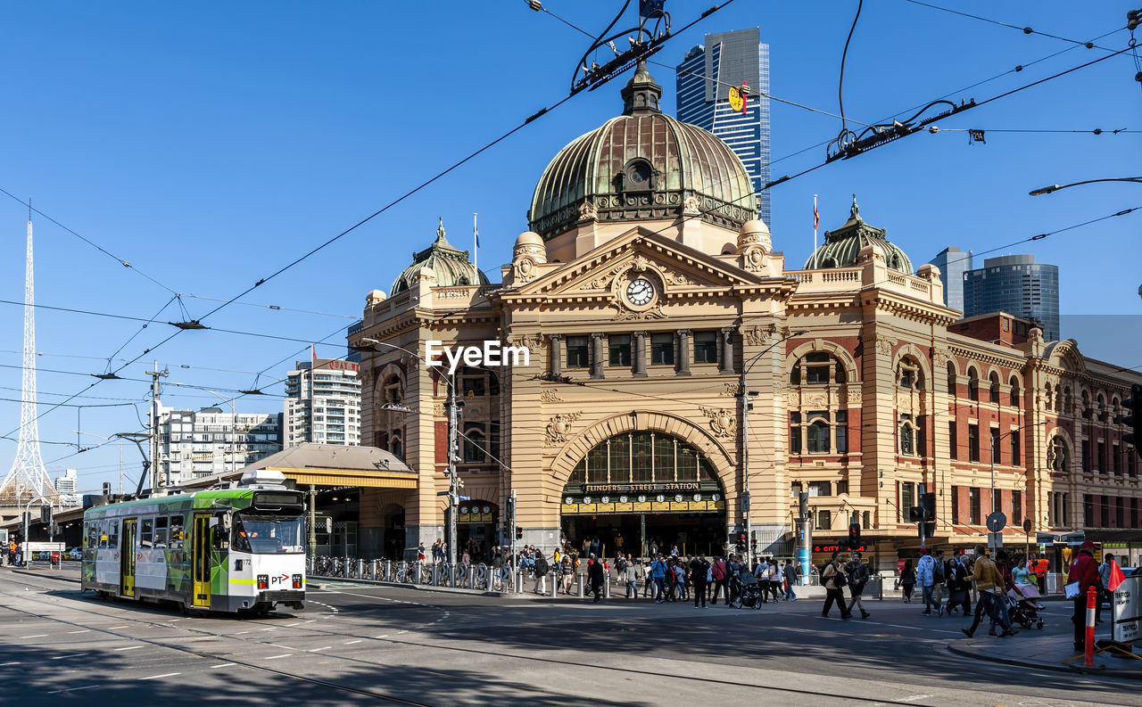 Group of people in city buildings. melbourne flinders street railway station.