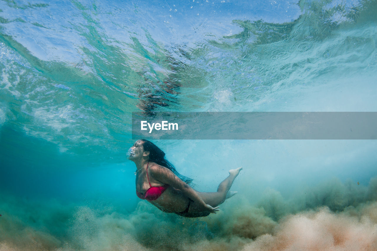 Woman wearing bikini while swimming in sea