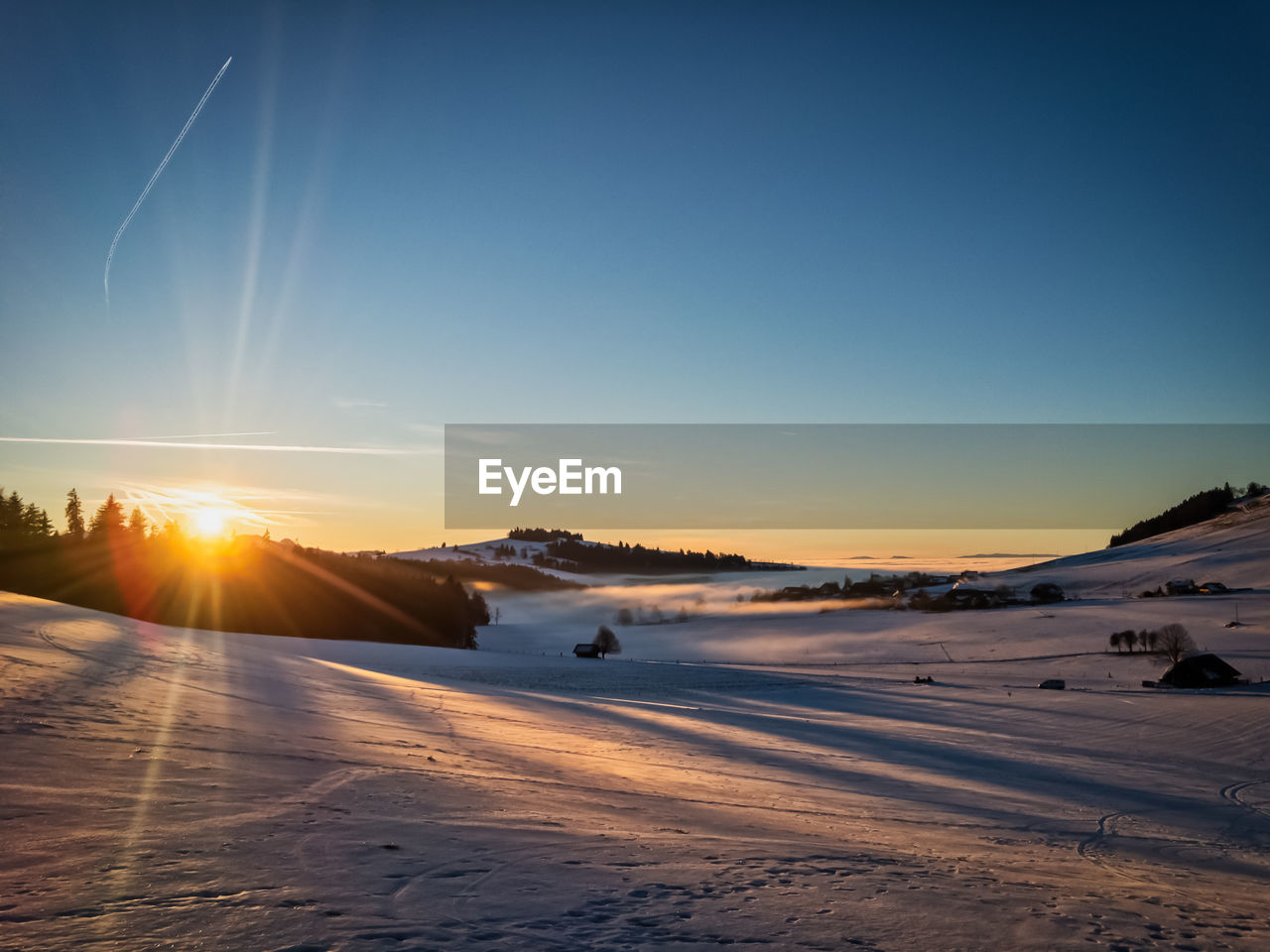 Scenic view of snow mountains against sky during sunset