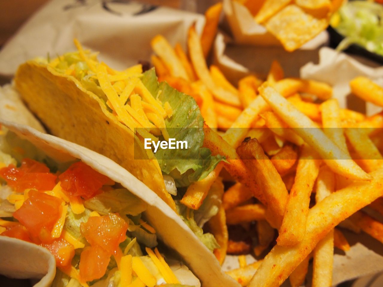 High angle view of tacos and french fries in plate