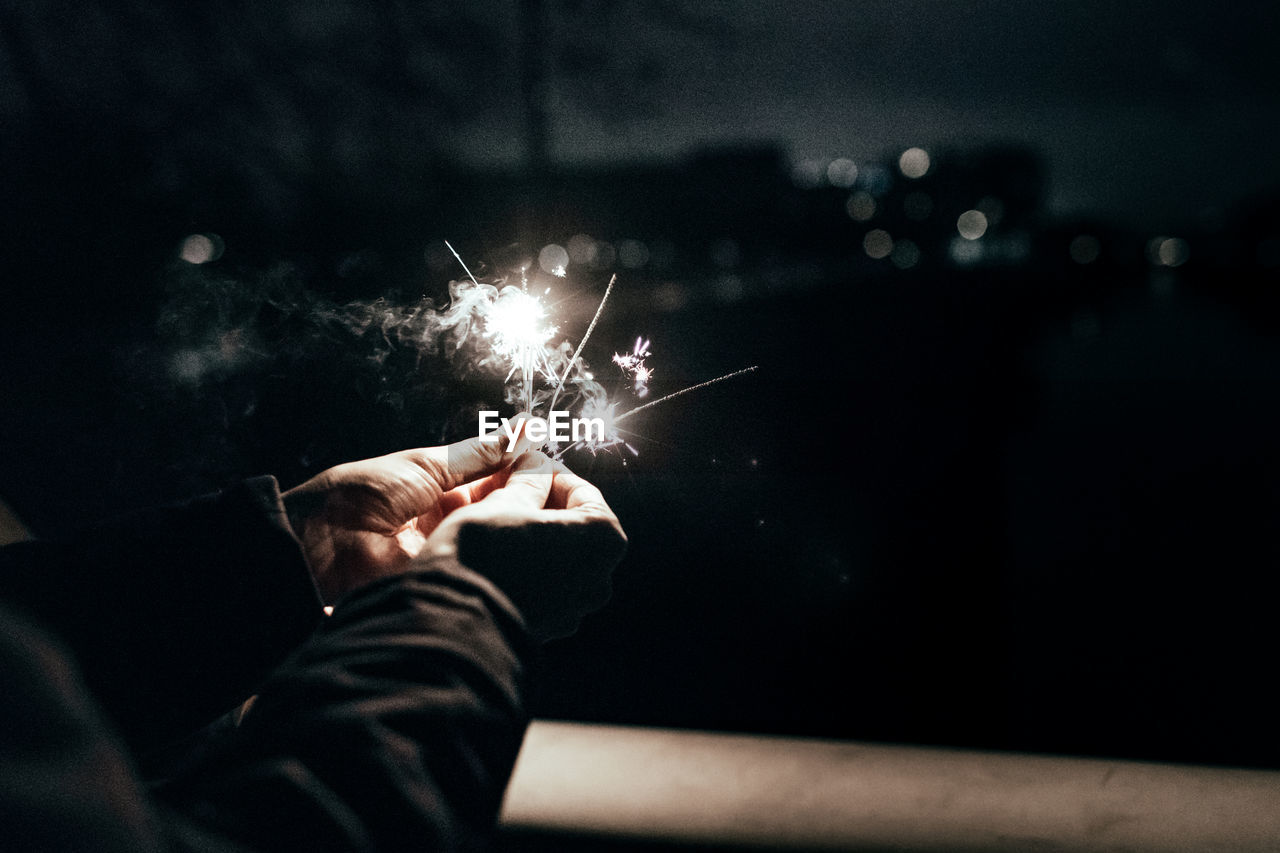 Close-up of person holding sparklers