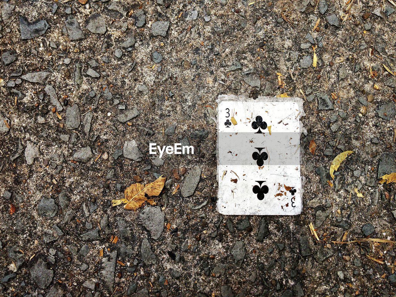 Close-up of playing card on ground