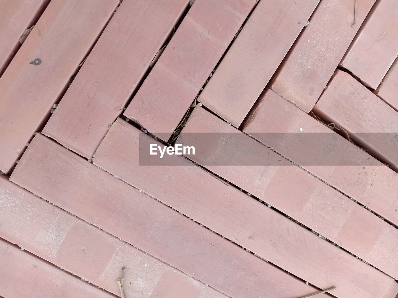 FULL FRAME SHOT OF ROOF TILES ON FOOTPATH