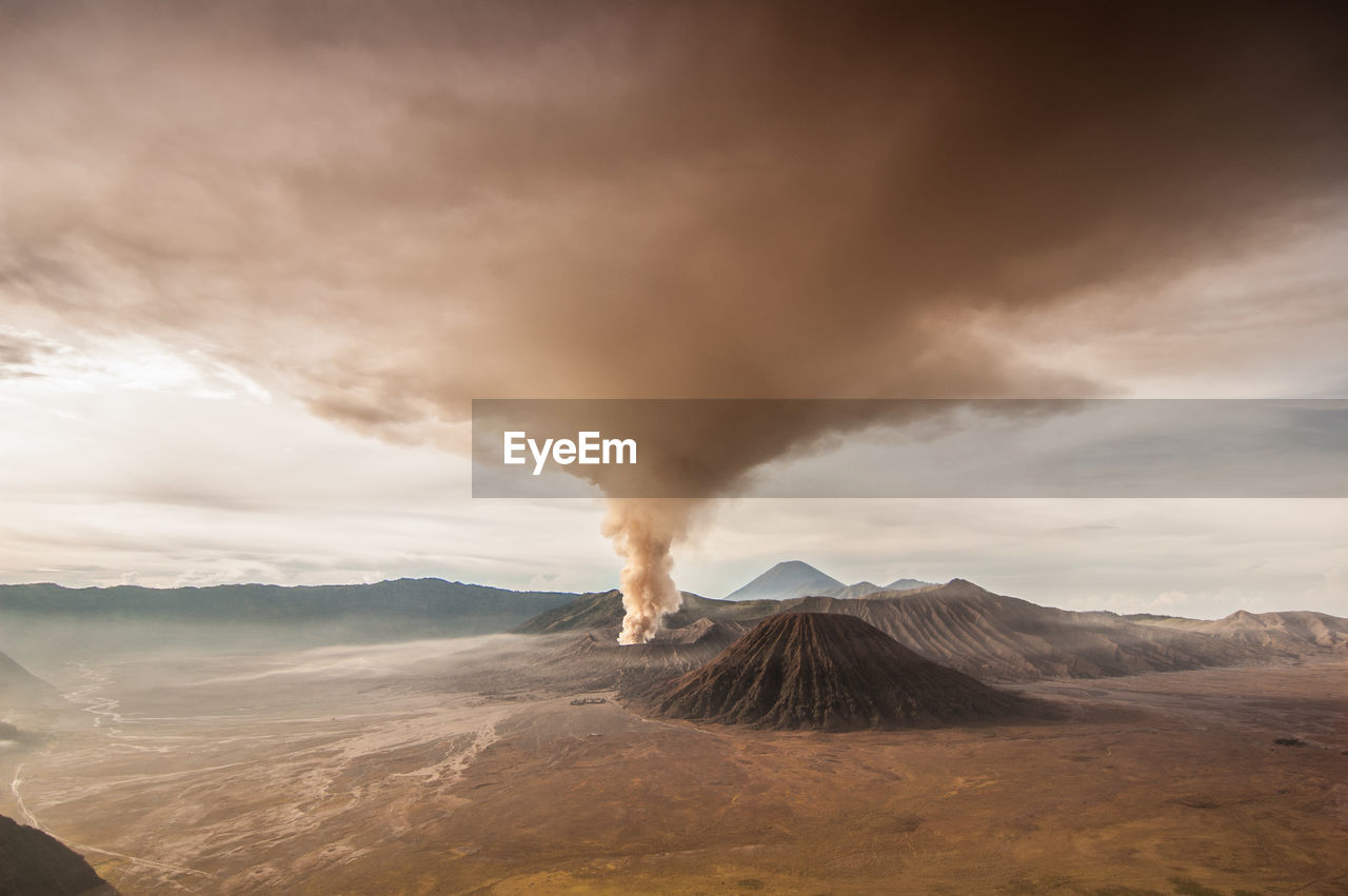 View of volcanic landscape against cloudy sky